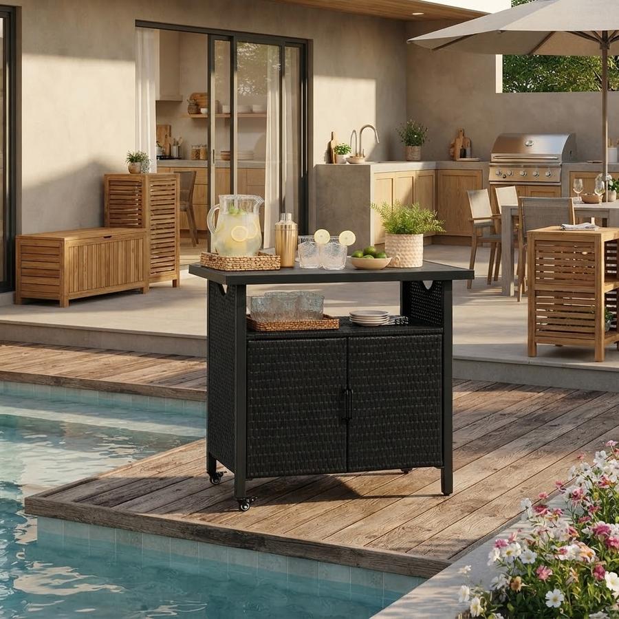 Wicker bar cart parked beside a grill on a back patio